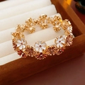 Macro shot of colorful enamel flower charms with gold base on a jewelry box background - Gold White Coffee
