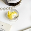 Macro shot of a clear round phone grip featuring a yellow cloud resin design on a desk - Yellow