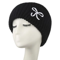 Black ribbed knit beanie with white embroidered bow detail on a white model head - Adult / Black