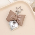 Detailed view of a brown faux leather bow keychain with a silver 3D heart charm and star clip - Coffee (K3613)