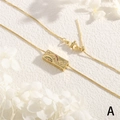 Macro shot of 18K gold plated necklace featuring moon and star zircon rectangular pendant - Gold - Multi Color Zirconia