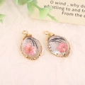Handmade oval resin pendants with pink dried flowers and golden wire wrapping - Pink Oval