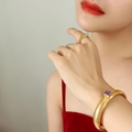 Gold plated cuff bracelet with purple gemstone and matching zircon ring set on wrist - 10mm / Purple