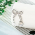 Elegant 925 silver bow stud earrings with sparkling cubic zirconia and dangling stones - White (Pair) + Silicone Earplugs