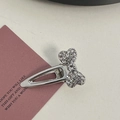 Detailed view of silver alloy hair clips with pink rhinestones, bow and heart designs - Silver/White Zirconia-Small Bow