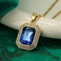 Luxurious gold necklace featuring a square cut blue sapphire pendant with diamond halo - Gold Dark Blue Gem