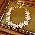 Detail of vintage gold bracelet with blue floral enamel links and champagne crystals - Bracelet (Gold-Blue)