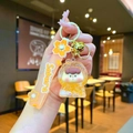 Close-up of cute liquid oil fruit keychain with Sakura silicone strap and bell charm - Sakura Rope Luminous Bubble Beads Orange Figure Style / Orange