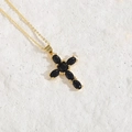 Chic hip-hop gold necklace with black zircon cross pendant on a white stone background - Black