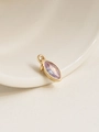 Macro shot of an 18K gold-plated teardrop pendant featuring a clear purple zircon stone - June/Purple