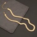 Close-up of golden snake chain necklace with lobster clasp on dark stone background - Gold Tight Snake Bone Chain (4#)