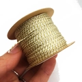 Detail of 1mm gold and white twisted cord on spool for DIY jewelry and crafts - Beige