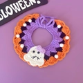 Detail van gehaakte Halloween halsband voor huisdieren met spook en oranje pompons - Geest Sjaal