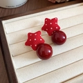 Macro view of red star fabric studs with glossy dark red dangling beads on beige tray - Polka Dot Star (45#)