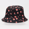 Detailed view of a black bucket hat featuring a red and white mushroom pattern design. - M (56-58cm) / Black Background Red Mushroom Print (#05)