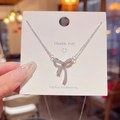 Silver bow pendant necklace with sparkling white zircons on a fine cable chain display - X572 Silver Bow Pavé Zirconia