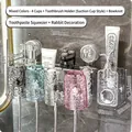 Wall-mounted toothbrush holder set with 4 colorful cups and automatic toothpaste dispenser - 4 Cups (Clear & Pink & Grey & Blue) + Bow + Dispenser + Rabbit