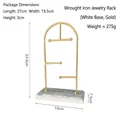 Golden arched T-bar jewelry display stand with a white marble base and earring hooks - Arch Jewelry Rack - White Base Gold Frame