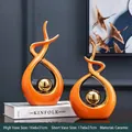 Modern abstract ceramic sculptures in bright orange and gold finish for living room decor - Orange Gold Abstract Pair