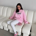 Pink oversized sweatshirt with green legacy lettering paired with white trousers - S / Pink