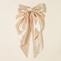 Detailed view of the champagne satin oversized bow hairclip with long hanging ribbons - Light Champagne