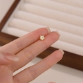 Orecchino a perno sole in oro argento S925 con zircone tenuto tra le dita - Sole Oro Pezzo Singolo