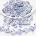 Macro shot of iridescent purple and green gradient star and moon glass beads for DIY jewelry - Green Purple Gradient