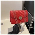 Red quilted V-pattern crossbody bag with gold heart-shaped lock and chain strap - Red