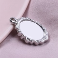 Macro view of silver oval 304 stainless steel pendant tray with vintage patterns - Steel Color (S1577-S) / Silver