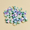 Macro shot of 10mm colorful clay flower beads with side holes for DIY jewelry making - Multicolor