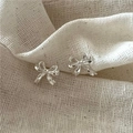 Elegant S925 sterling silver bow knot stud earrings with polished finish on beige fabric - 925 Silver / Silver