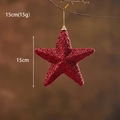 Sparkling red 15cm Christmas tree star topper with glitter finish on a branch - 15cm Red Star Ornament