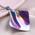 Macro shot of 18k gold plated iridescent wave square pendant on pink silk background - Rainbow Necklace
