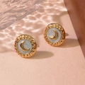 Detail view of retro gold crescent moon earrings with light blue enamel on warm background - Light Green