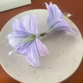 Artificial purple gradient lily hair clips with two flowers on a ceramic plate - Elegant Purple Lily Hair Clip