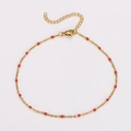 Detail of gold stainless steel anklet featuring vibrant red beads and extender chain - Red