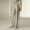 Pantaloni larghi in raso verde chiaro da donna con vita alta elastica e finitura lucida - S / verde chiaro