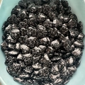 Polished 2cm heart-shaped natural black stone with white spotted patterns in a bowl - Snowflake Obsidian