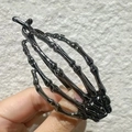 Gothic black skull hand hair claw clip for Halloween styling with metallic finish - Skeleton Hand Twist Black