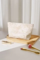 Close-up of white cotton linen makeup bag featuring elegant floral embroidery details - Large / Beige