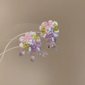 Macro shot of handmade beaded flower earrings with pink petals and purple drop crystals - Flower Cluster Style (70#)