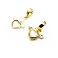 Detailed view of gold winged heart charms with micro-pave cubic zirconia accents - Hollow Wings Heart Zirconia