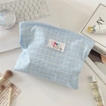 Flat lay view of a light blue plaid waffle fabric cosmetic bag with letter embroidery - Light Blue