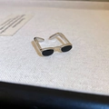 Macro view of a creative sunglasses-shaped open ring with black enamel lenses - Silver Frame Black Lens