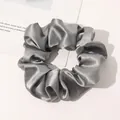Detail shot of silver-grey silk scrunchie with soft satin texture and elegant sheen - Dark Gray