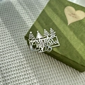 Macro shot of silver Merry Christmas 2025 cake topper on a green textured gift box - Christmas Tree Merry Christmas 2025 / 1.3mm / Silver