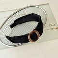 Black knit padded headband featuring a vintage amber resin geometric circle ornament - Black