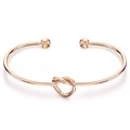 Detalle de la pulsera abierta de acero inoxidable en oro rosa con nudo y extremos de esfera - Oro de 18K / Dorado