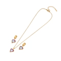 Golden jewelry set with purple-pink heart pendants on a clean white background - Heart Style