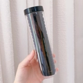 Set of elastic black hair ties in a transparent storage tube held by hand - 1# Black Set (20pcs Tube)